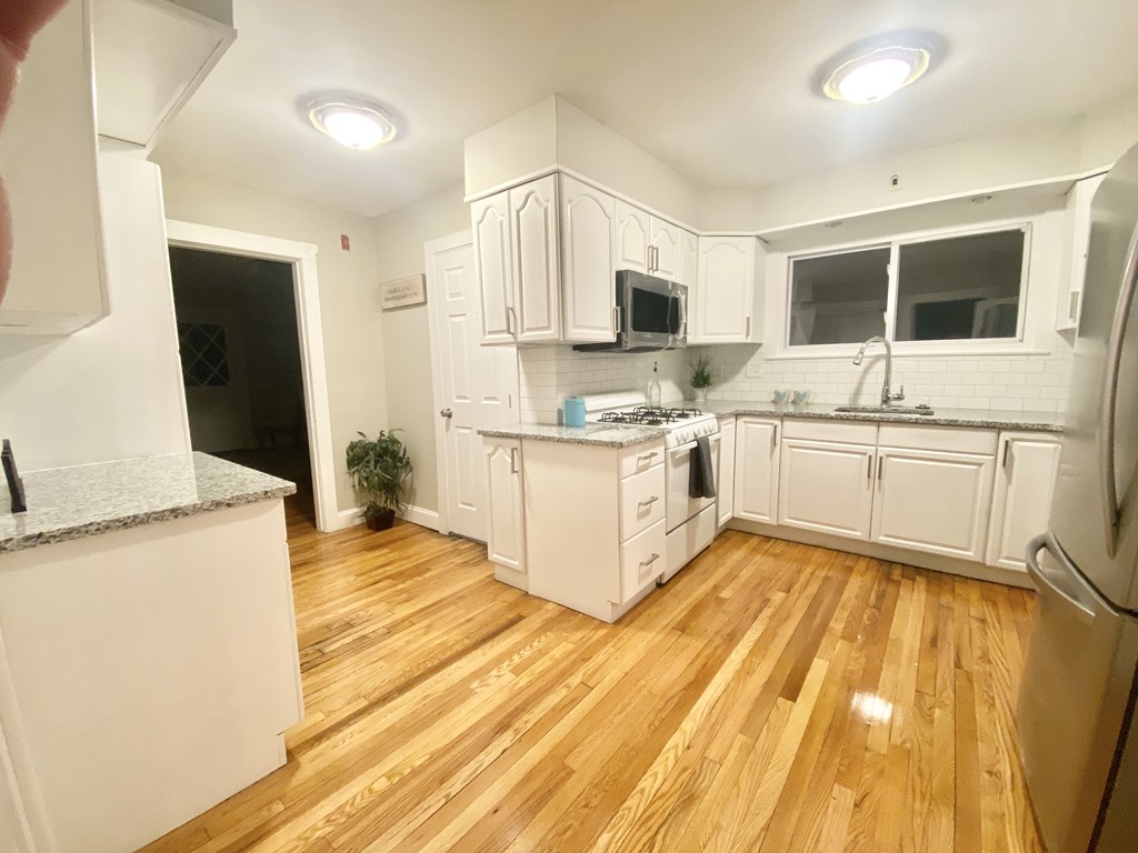 12-14 Howes Street Springfield, MA 01118 - Photo 33 of 35 a large kitchen with a stove top oven