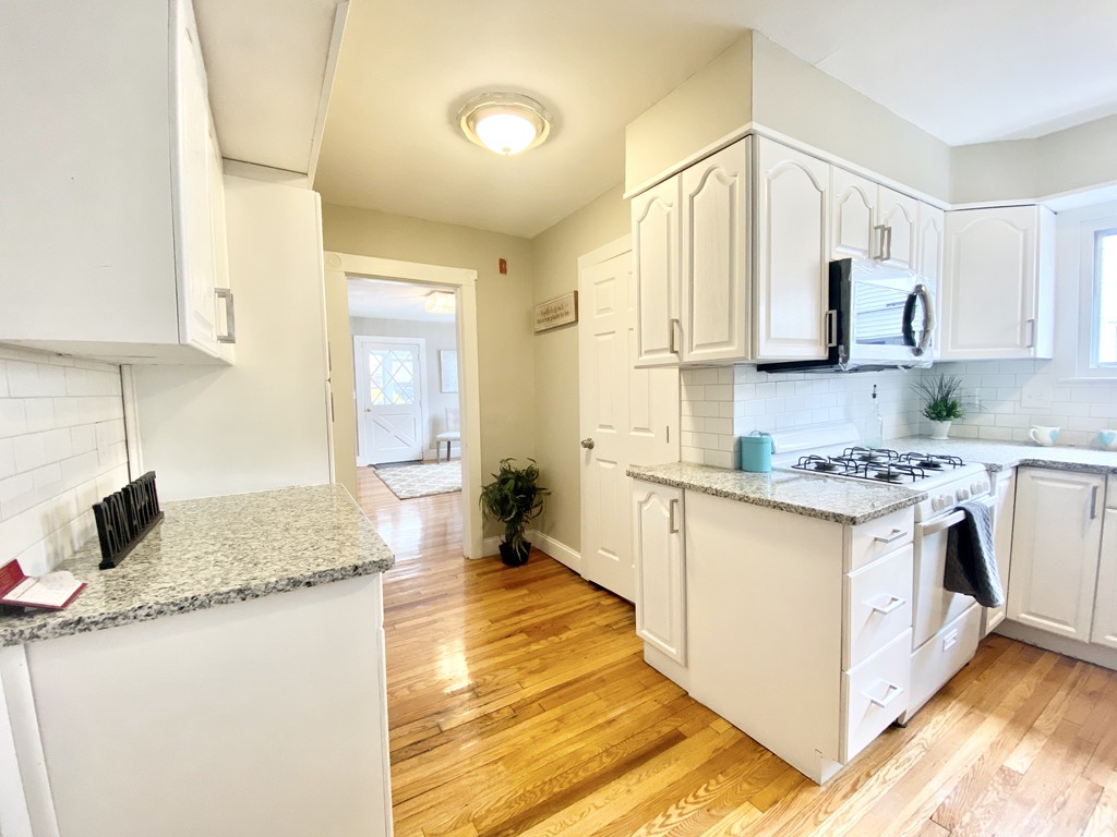 12-14 Howes Street Springfield, MA 01118 - Photo 34 of 35 a kitchen with stainless steel appliances granite countertop a sink stove and cabinets