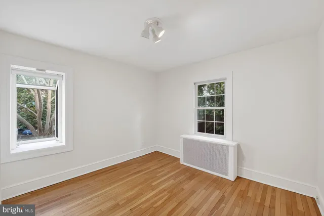 a bathroom with a toilet a sink and a mirror