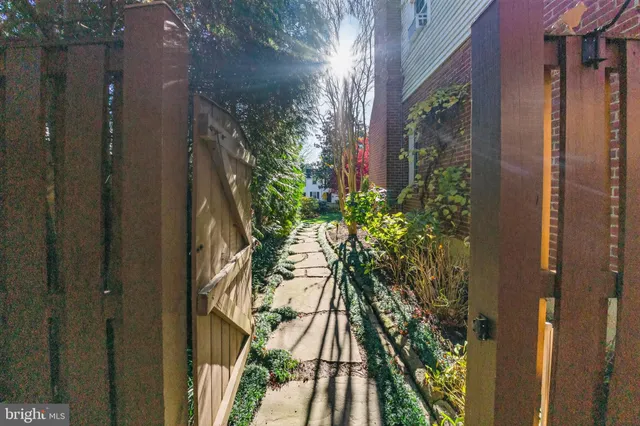 a view of a white house with a street