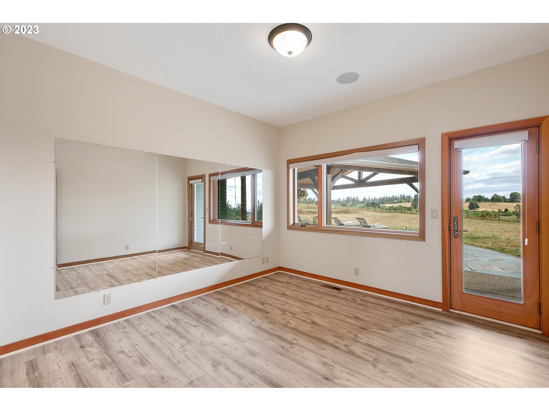 14315 Southwest Westfall Road Sherwood, OR 97140 - Photo 17 of 45 a view of an empty room with wooden floor and a window