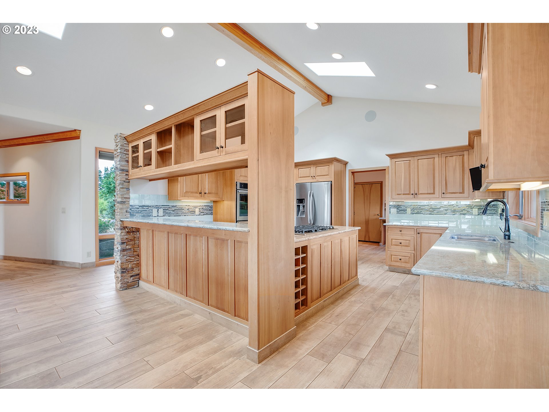 14315 Southwest Westfall Road Sherwood, OR 97140 - Photo 9 of 45 a open kitchen with stainless steel appliances granite countertop a refrigerator a sink and a wooden floors