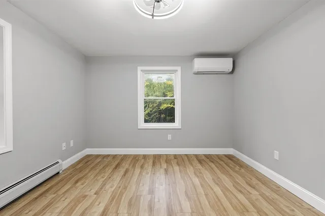 wooden floor in an empty room with a window