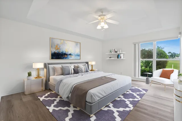 a bedroom with a bed tv and window