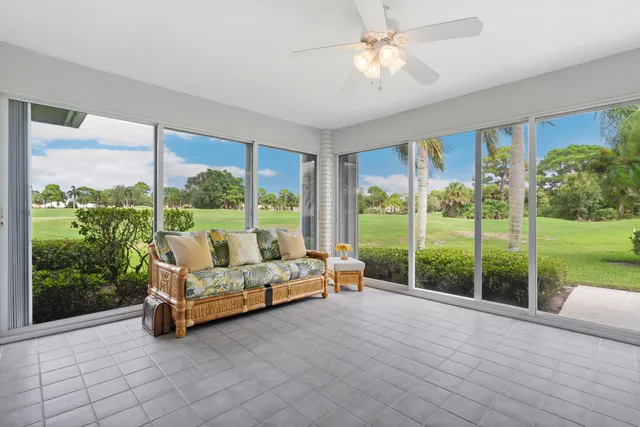a bedroom with furniture and large windows