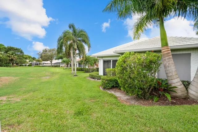 an aerial view of a house with outdoor space and a lake view