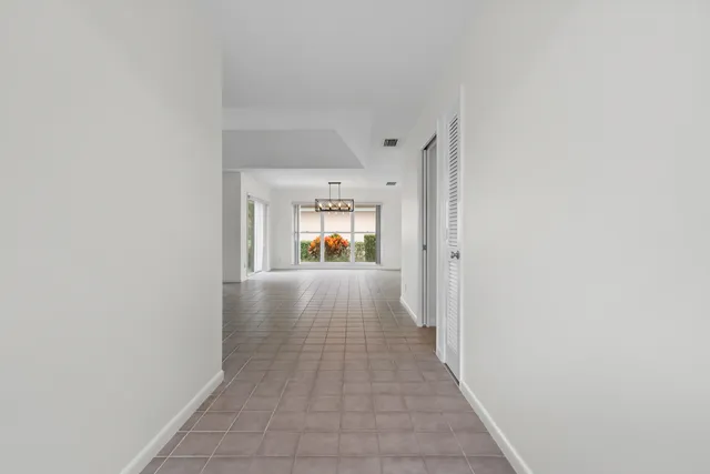 a view of hallway with wooden floor