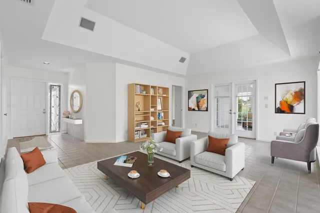 a view of a livingroom with furniture wooden floor and windows