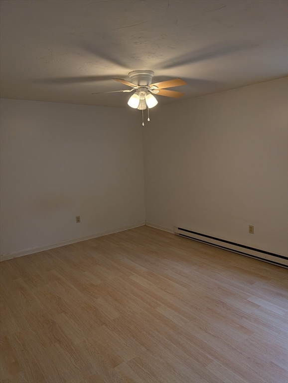 653 Plantation Street, Unit 6A Worcester, MA 01605 - Photo 13 of 14 a view of a room with hardwood floor and a ceiling fan