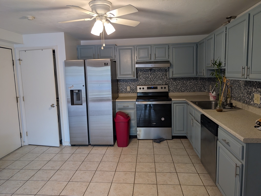 653 Plantation Street, Unit 6A Worcester, MA 01605 - Photo 2 of 14 a kitchen with stainless steel appliances granite countertop a refrigerator a sink a stove a microwave and island