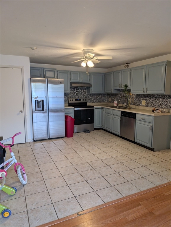 653 Plantation Street, Unit 6A Worcester, MA 01605 - Photo 5 of 14 a kitchen with stainless steel appliances granite countertop a sink and cabinets