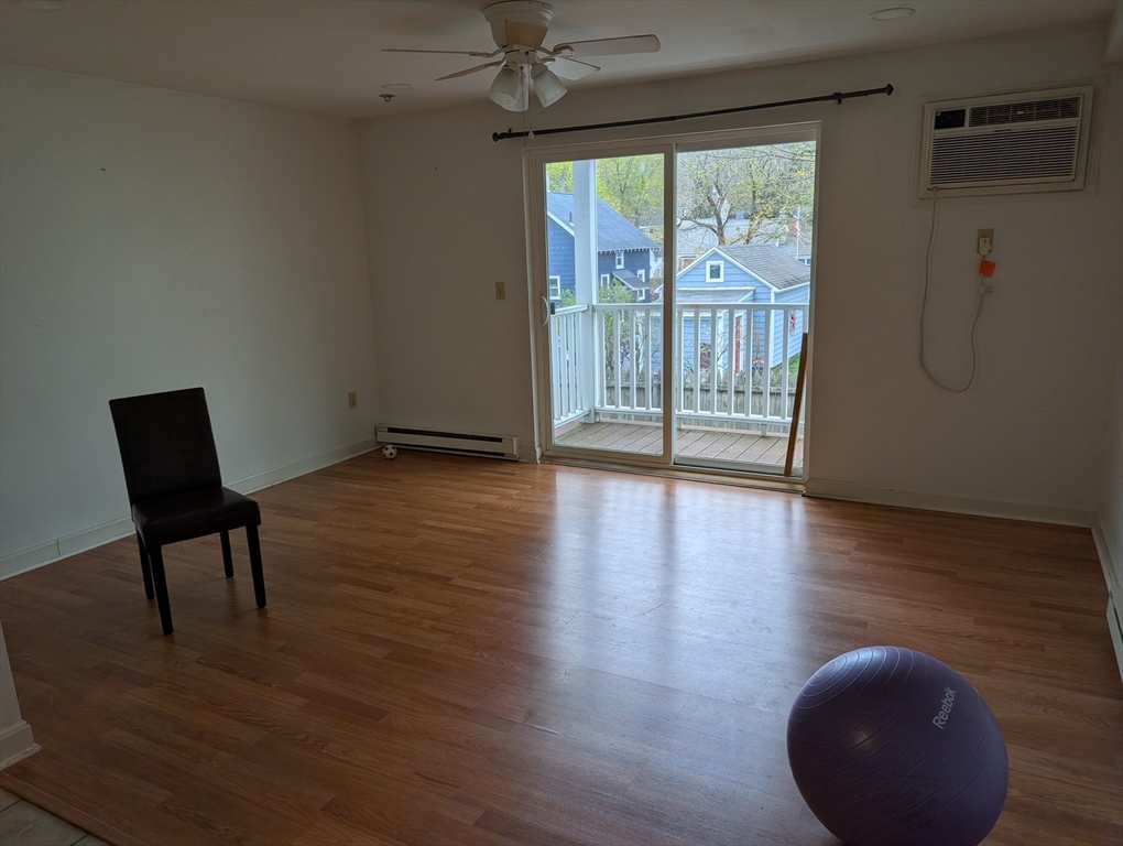 653 Plantation Street, Unit 6A Worcester, MA 01605 - Photo 6 of 14 a view of an empty room with wooden floor and a window