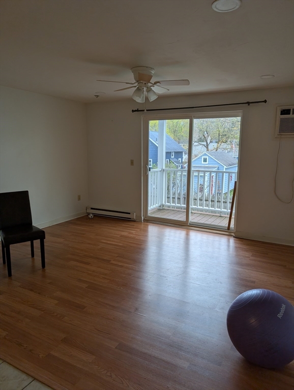 653 Plantation Street, Unit 6A Worcester, MA 01605 - Photo 7 of 14 a view of an empty room with wooden floor and a window
