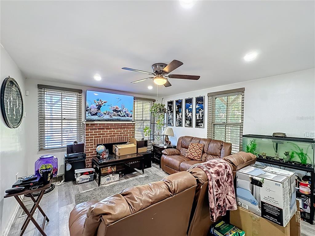 7717 Clarcona Ocoee Road Orlando, FL 32818 - Photo 13 of 63 a living room with furniture a window and a flat screen tv