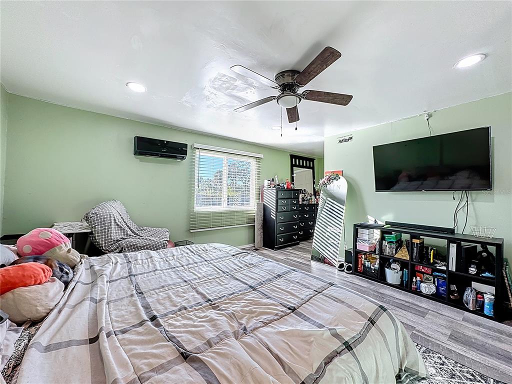 7717 Clarcona Ocoee Road Orlando, FL 32818 - Photo 15 of 63 a bedroom with a bed and a flat screen tv