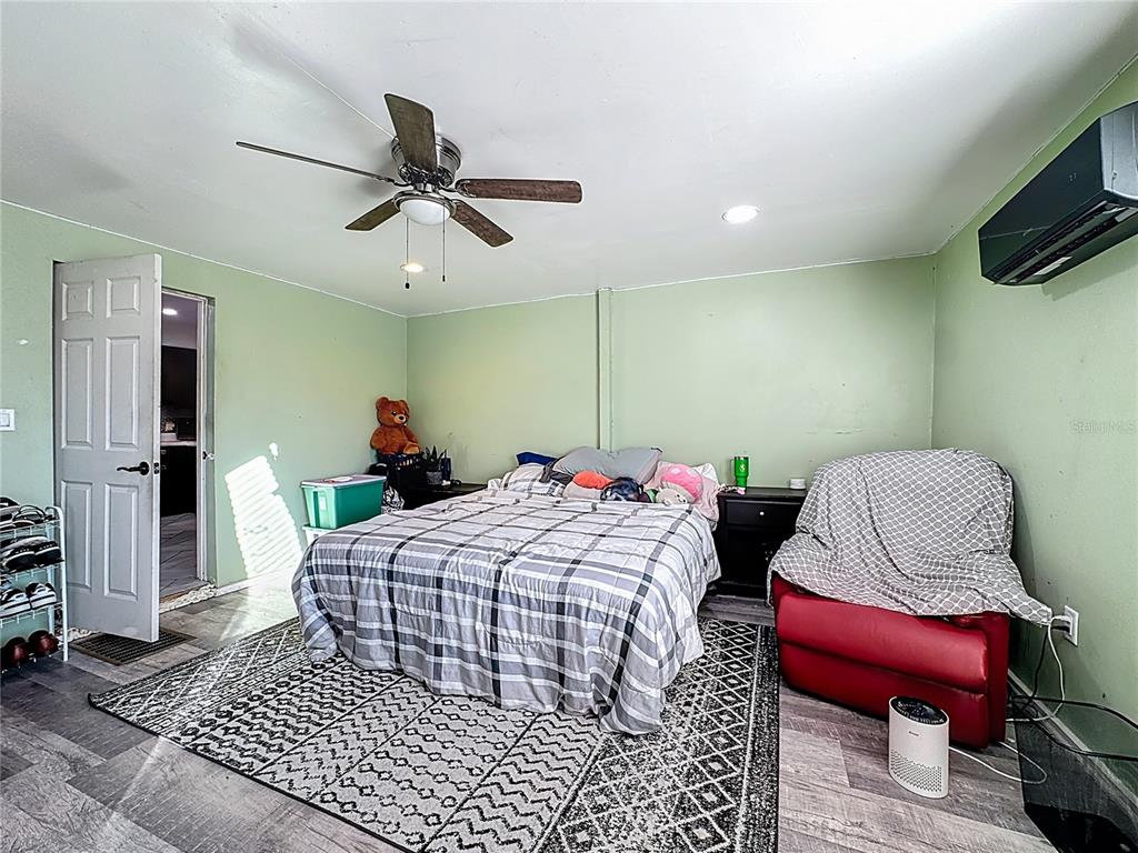 7717 Clarcona Ocoee Road Orlando, FL 32818 - Photo 17 of 63 a bed room with a bed mirror and a chair