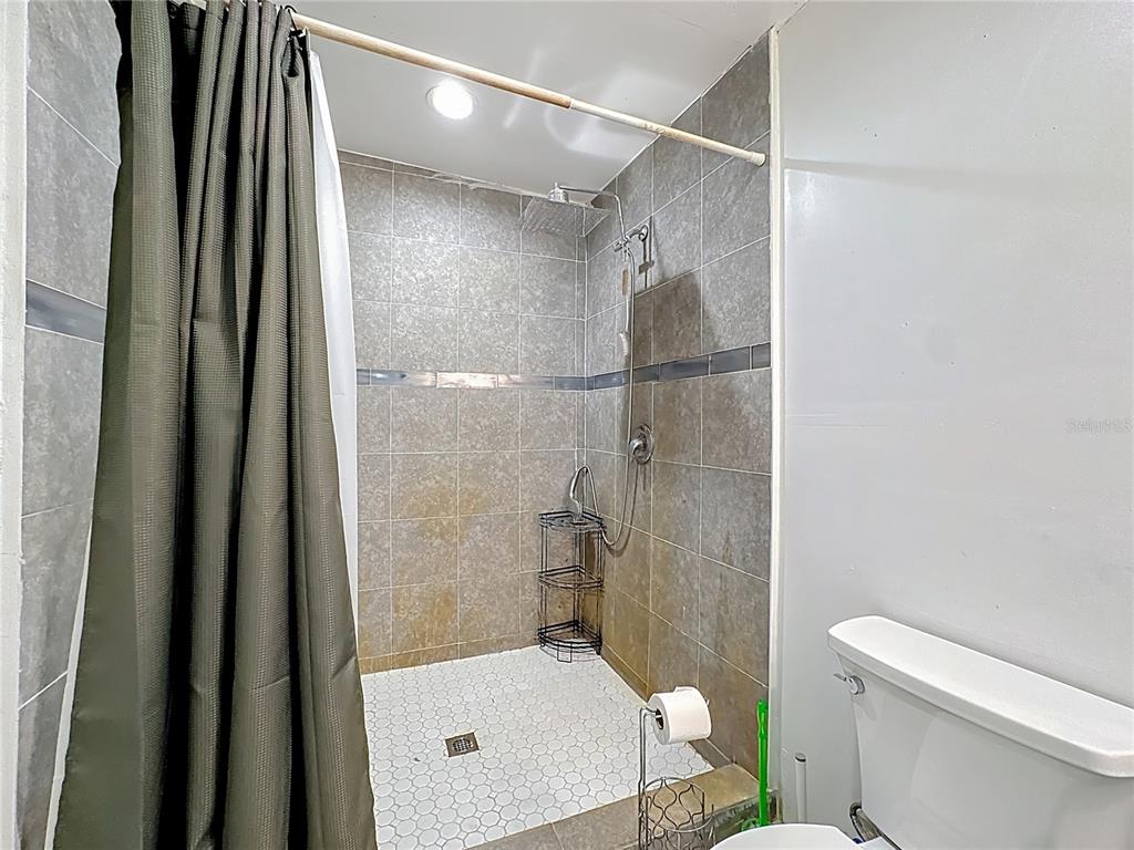 7717 Clarcona Ocoee Road Orlando, FL 32818 - Photo 20 of 63 a bathroom with a shower and a toilet