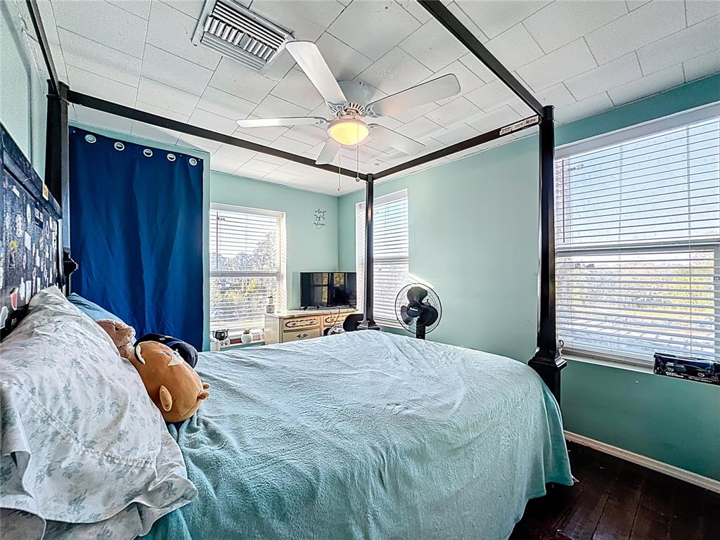 7717 Clarcona Ocoee Road Orlando, FL 32818 - Photo 28 of 63 a bedroom with a bed and a window