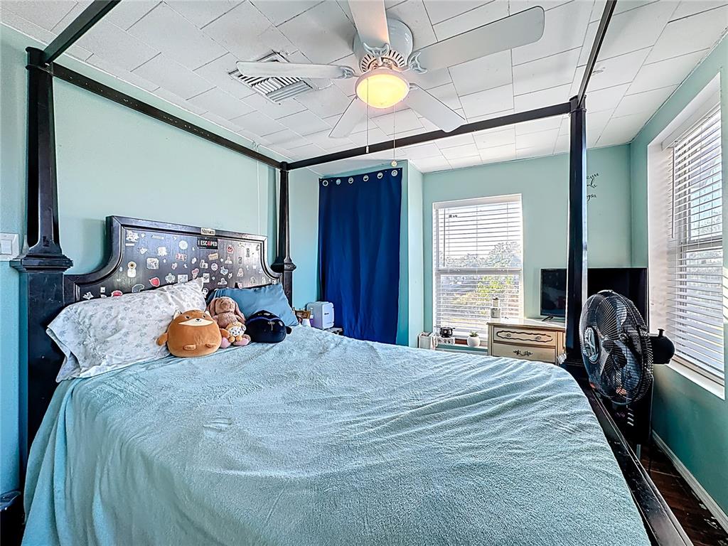 7717 Clarcona Ocoee Road Orlando, FL 32818 - Photo 29 of 63 a bedroom with bed and a chandelier