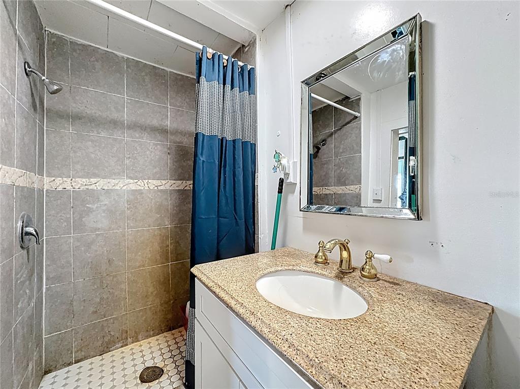 7717 Clarcona Ocoee Road Orlando, FL 32818 - Photo 31 of 63 a bathroom with a sink and a mirror