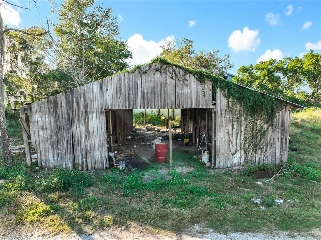7717 Clarcona Ocoee Road Orlando, FL 32818 - Photo 40 of 63 a view of a backyard with plants and a slide