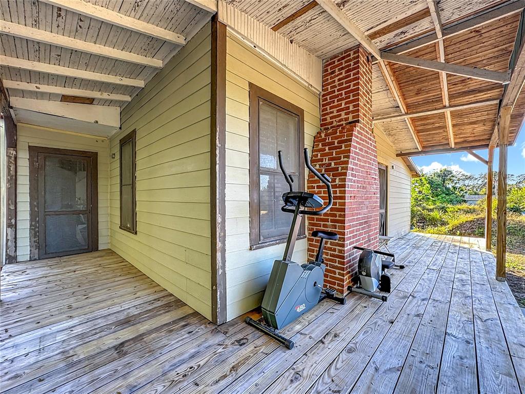 7717 Clarcona Ocoee Road Orlando, FL 32818 - Photo 4 of 63 a view of a patio with wooden floor and roof