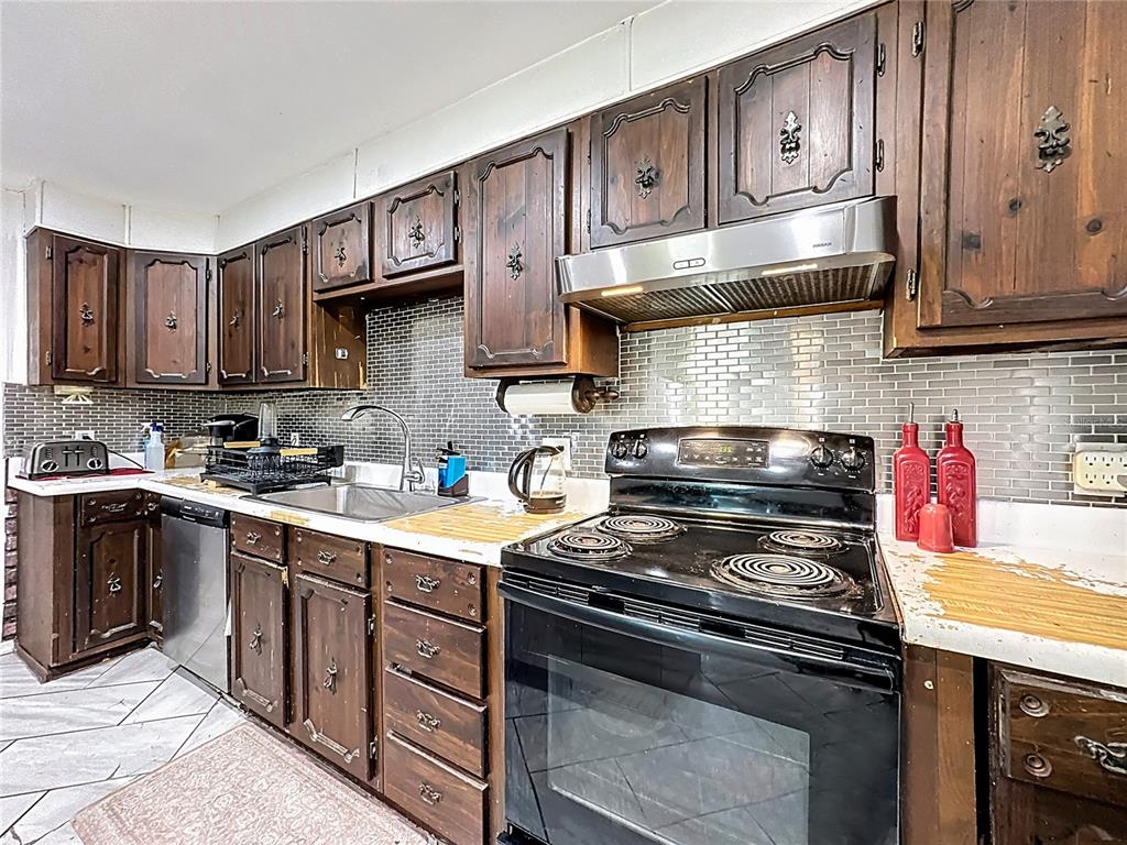 7717 Clarcona Ocoee Road Orlando, FL 32818 - Photo 5 of 63 a kitchen with stainless steel appliances granite countertop a stove and a sink