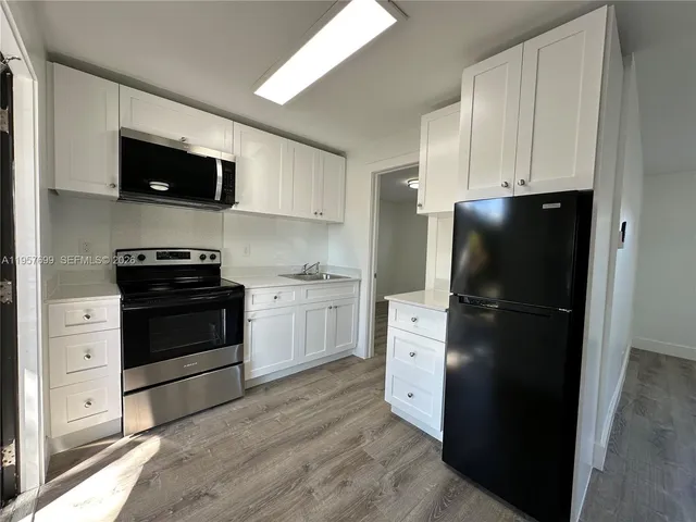 a kitchen with a refrigerator stove and microwave