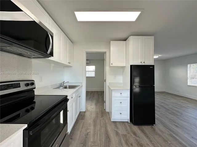 a kitchen with stainless steel appliances a refrigerator and a stove top oven