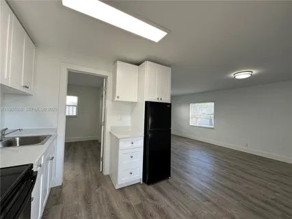 a kitchen with granite countertop a refrigerator and a stove