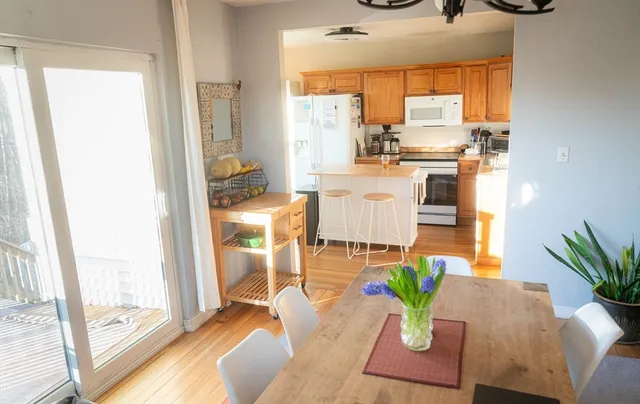 a living room with furniture appliances and a large window