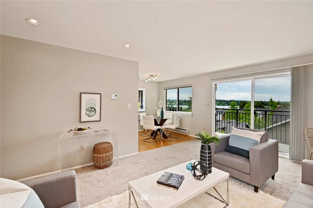 911 North 73rd Street, Unit 407 Seattle, WA 98103 - Photo 1 of 27 a living room with furniture and a table