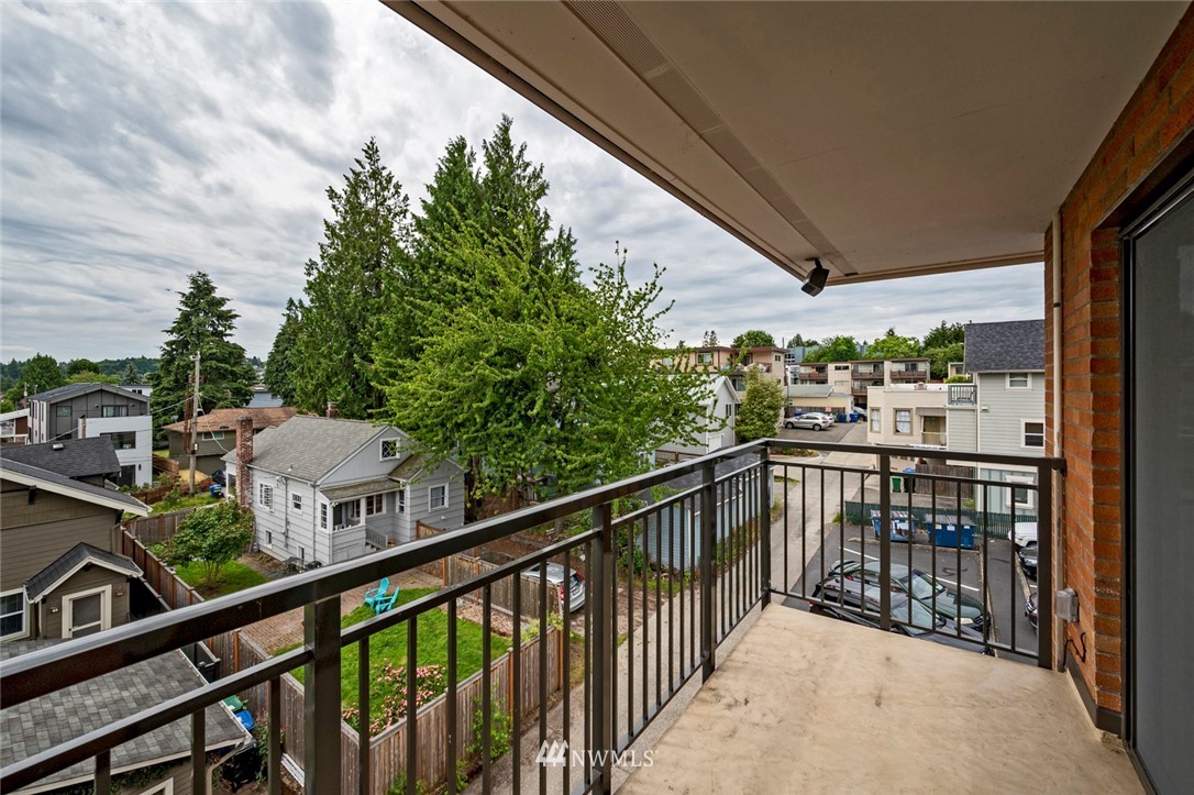 911 North 73rd Street, Unit 407 Seattle, WA 98103 - Photo 17 of 27 a view of a balcony with wooden floor