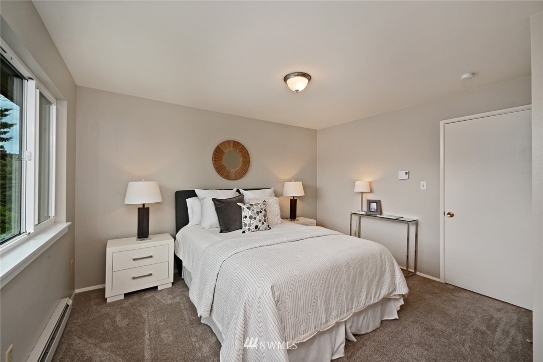 911 North 73rd Street, Unit 407 Seattle, WA 98103 - Photo 20 of 27 a bedroom with a bed and a window