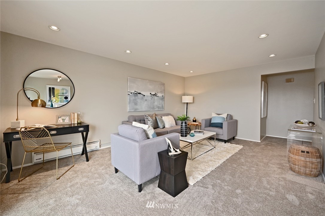 911 North 73rd Street, Unit 407 Seattle, WA 98103 - Photo 5 of 27 a living room with furniture a rug and a window