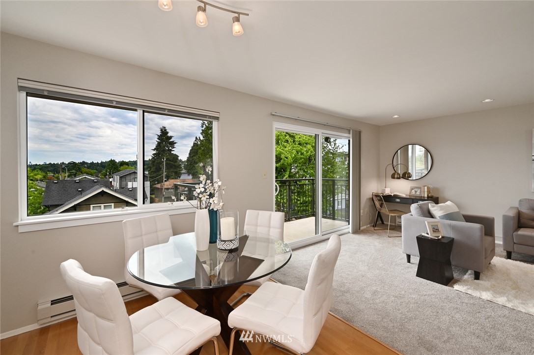 911 North 73rd Street, Unit 407 Seattle, WA 98103 - Photo 7 of 27 a living room with furniture and a large window