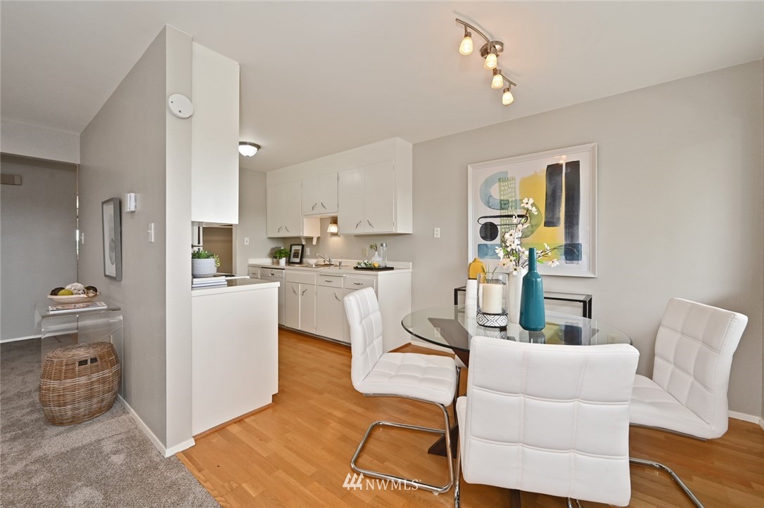 911 North 73rd Street, Unit 407 Seattle, WA 98103 - Photo 8 of 27 a living room with furniture and a dining table with kitchen view