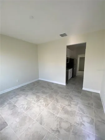 a view of an empty room with a fireplace