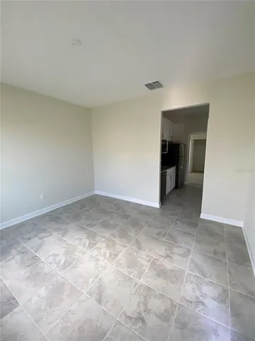 a view of an empty room with a fireplace