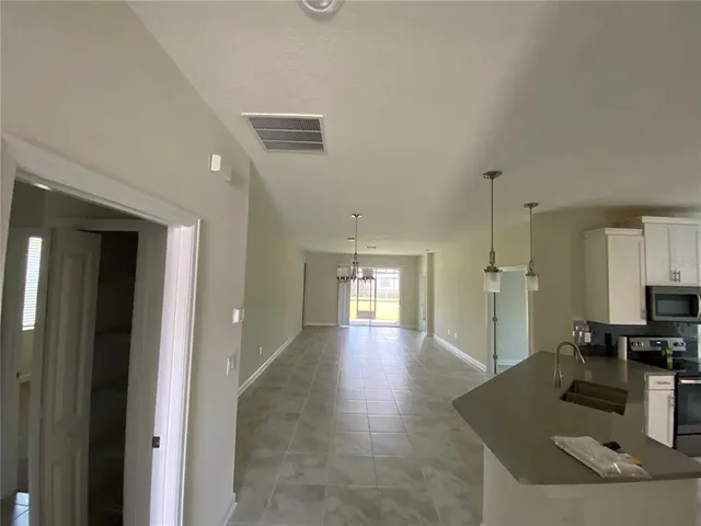 a view of a kitchen with a sink and a refrigerator