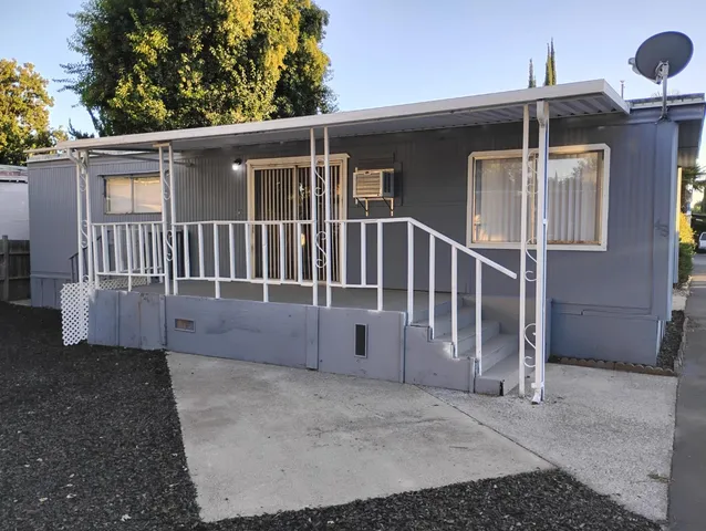 a view of a house with wooden fence