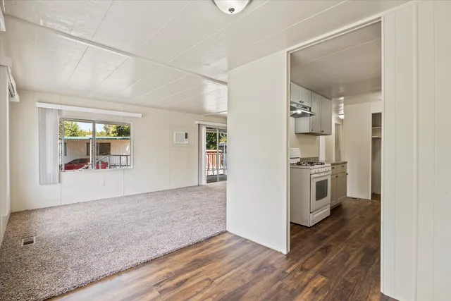 a view of kitchen with refrigerator and window