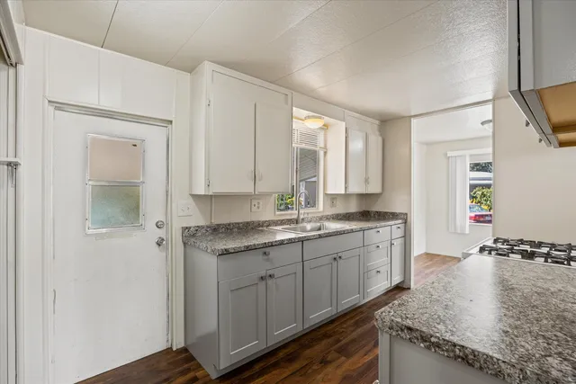 a kitchen with a sink stove and cabinets
