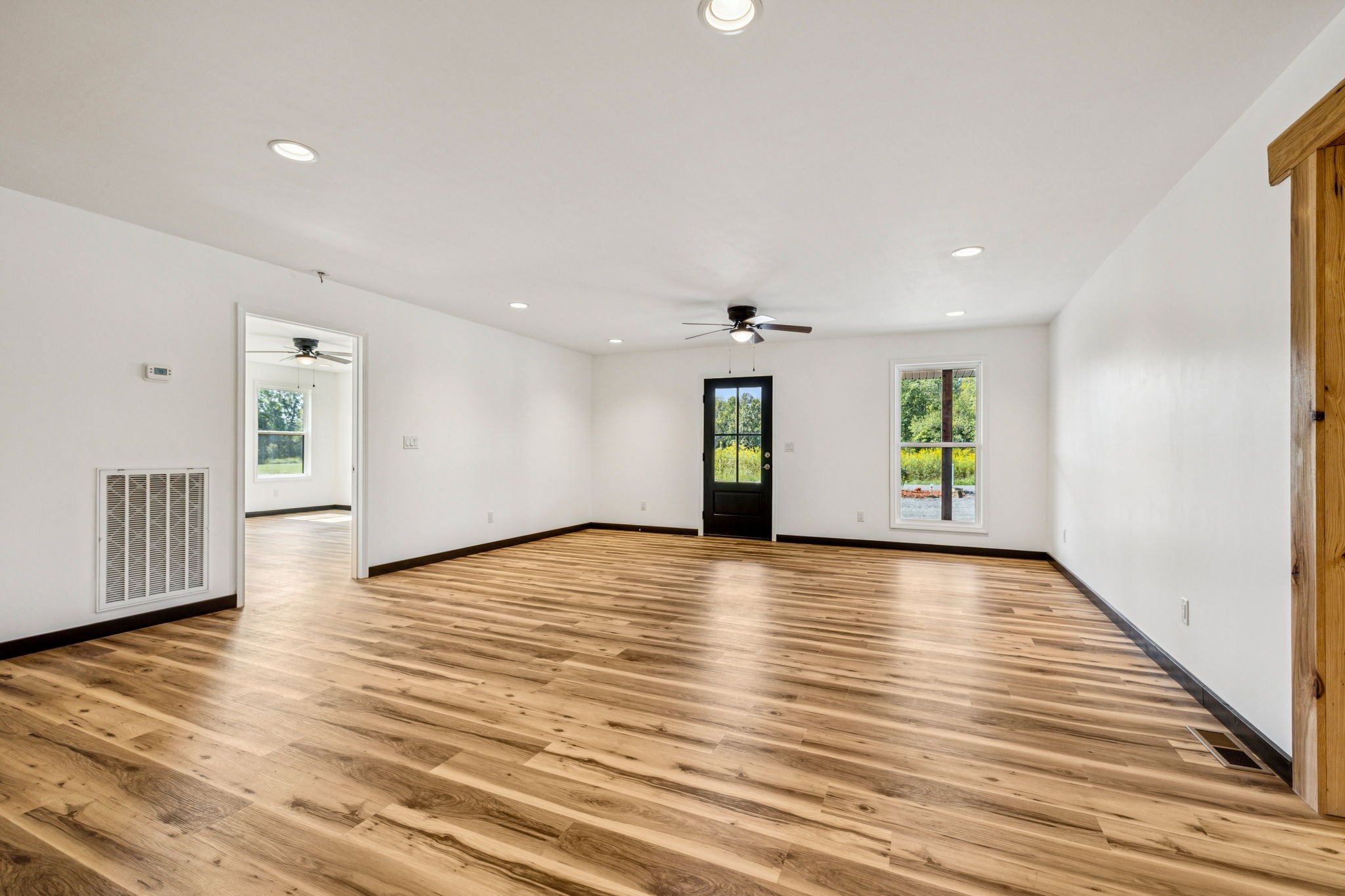 233 Ralph Spivey Lane Gainesboro, TN 38562 - Photo 11 of 45 a view of an empty room with wooden floor and windows