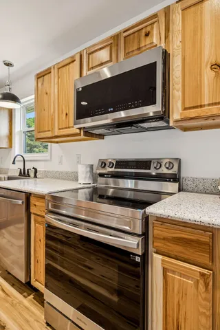 a view of a room with wooden floor and white walls