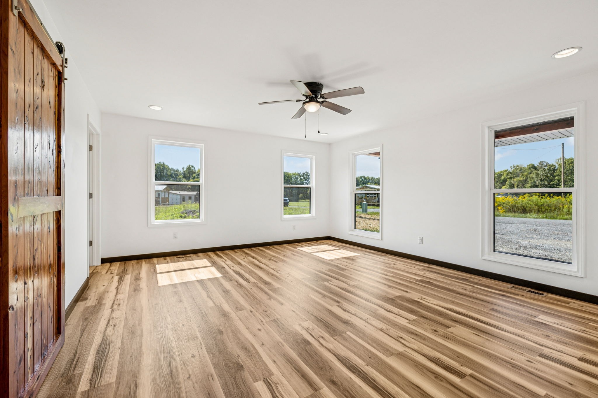 233 Ralph Spivey Lane Gainesboro, TN 38562 - Photo 22 of 45 a view of an empty room with a window and wooden floor
