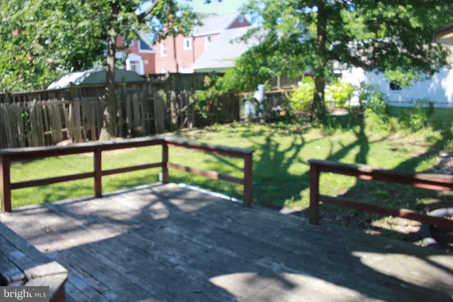 a view of a yard with wooden fence