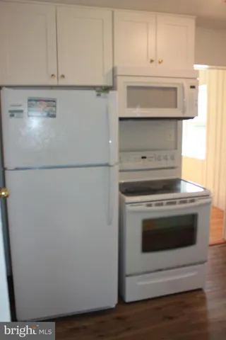 a stove top oven sitting inside of a kitchen