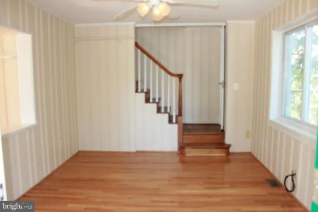 a view of entryway with wooden floor and stairs