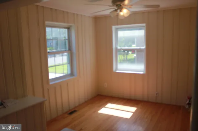 an empty room with windows and closet